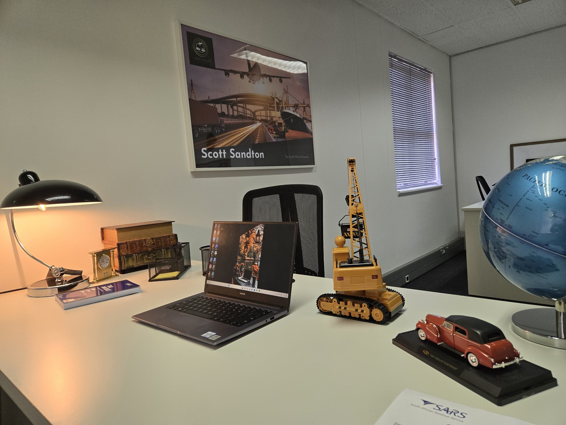 Scott Sandton office display with model vehicles and the air, road and sea freight poster